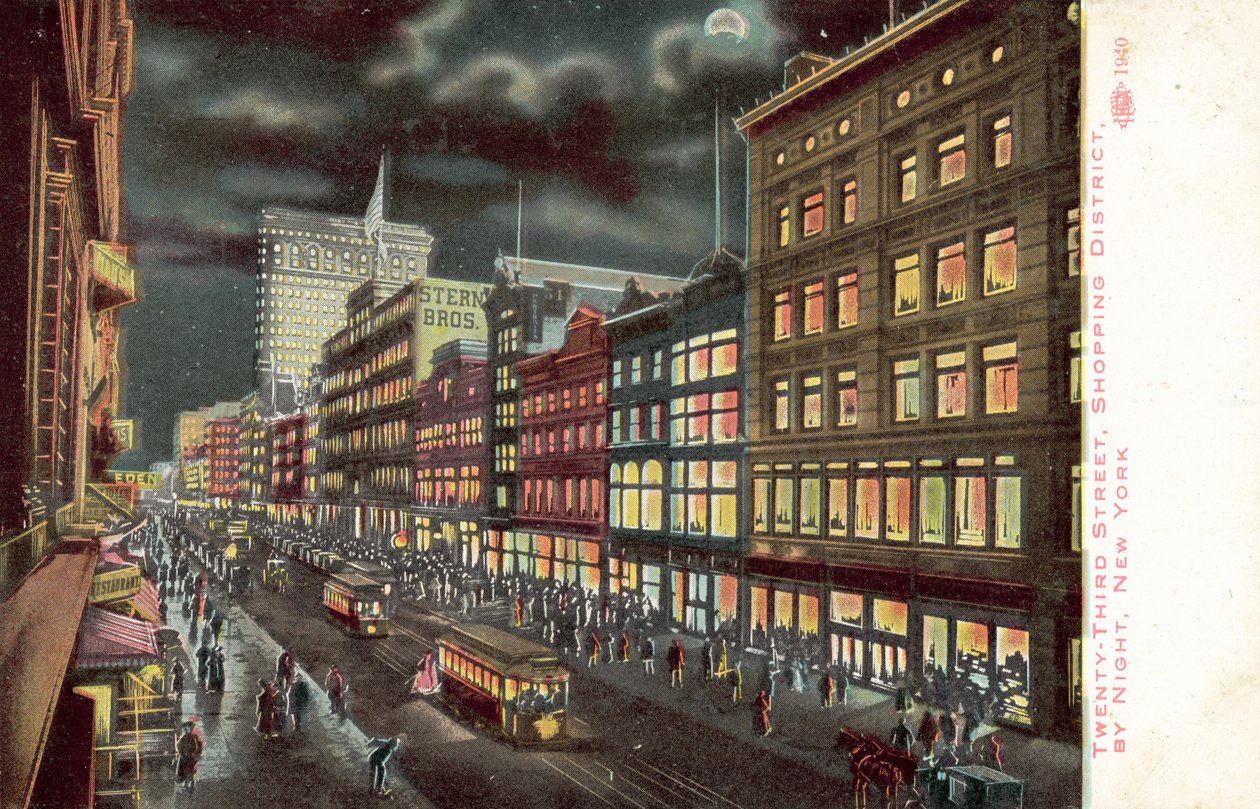 Einkaufsviertel der 23. Straße, New York, bei Nacht von American School