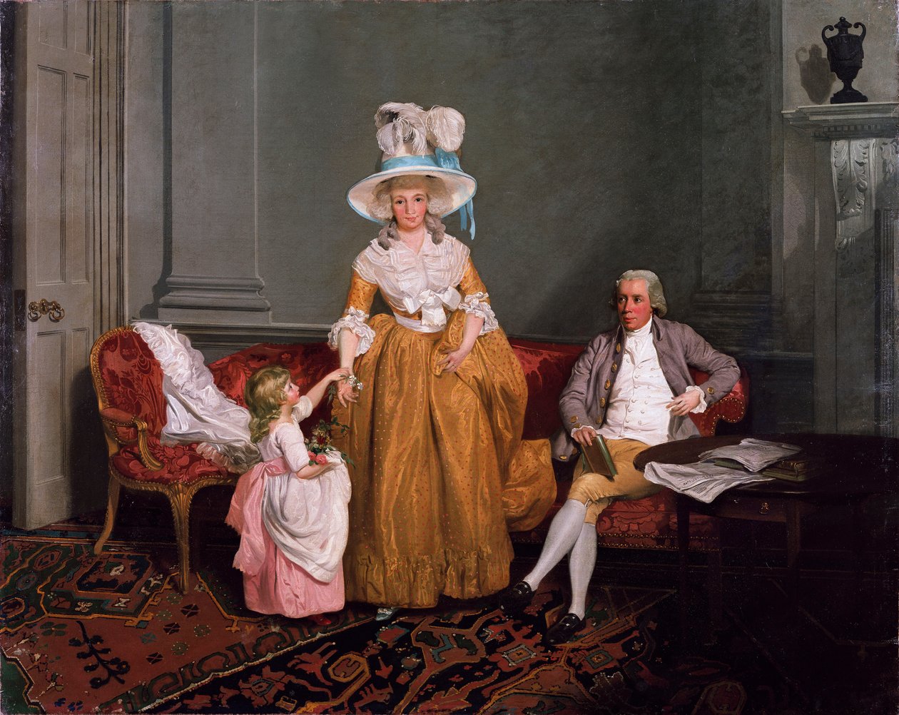 Eine Familiengruppe, der Vater sitzt, die Mutter und Tochter stehen, im ...