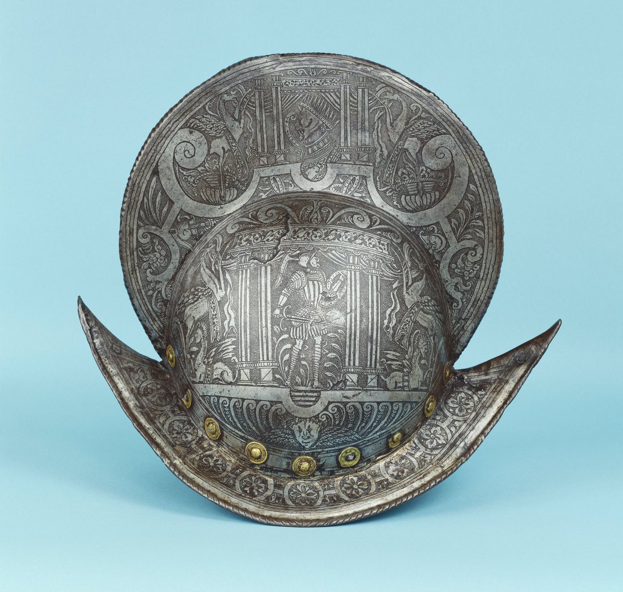 Ein Kamm-Morion, graviert mit Cherubimköpfen, Sphinxen und geflügelten Pferden, in der Mitte ein pseudo-klassischer Krieger in zeitgenössischer Rüstung mit Schwert und Schild von German School