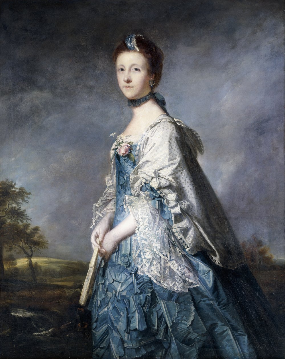 Porträt von Anne, Gräfin Winterton, stehend, dreiviertel Länge, in einem blauen Kleid und einer spitzenbesetzten Stola, einen Fächer haltend, in einer Landschaft von Joshua Reynolds