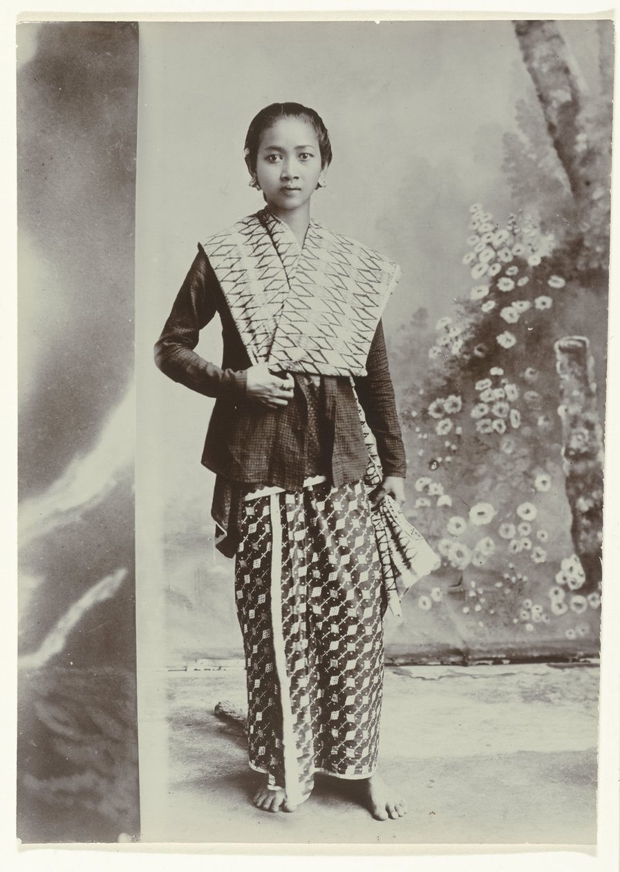 Studio-Porträt einer jungen javanischen Frau in einem Sarong mit Batikmuster und einem Hemd mit Karomuster von Kassian Cephas