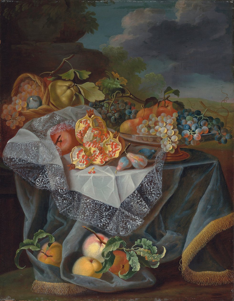 Trauben, Birnen und ein Apfel auf einem Glasgefäß, Granatäpfel und ein geflochtener Korb mit Früchten auf einem drapierten Tisch, und eine Parklandschaft dahinter von Maximilian Pfeiler or Pfeiller