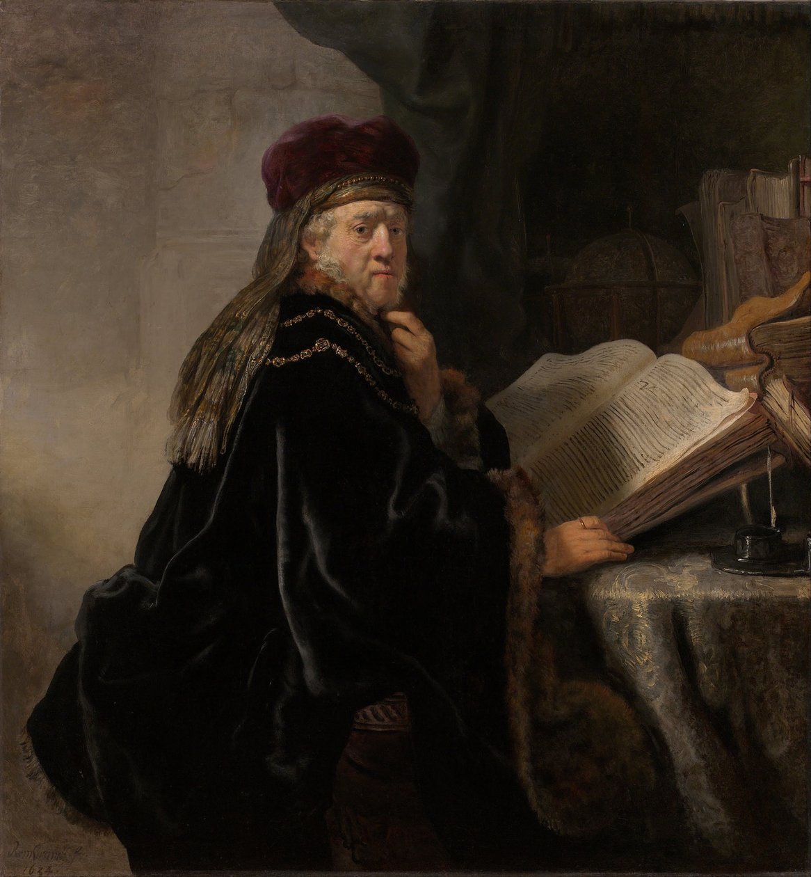 Ein Gelehrter sitzt an einem Schreibtisch von Rembrandt van Rijn