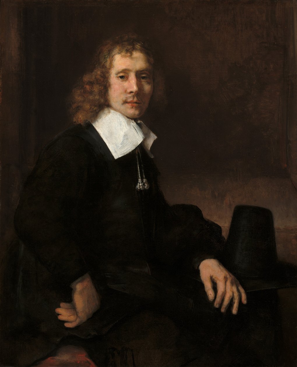 Ein junger Mann sitzt an einem Tisch, möglicherweise Govaert Flinck von Rembrandt van Rijn