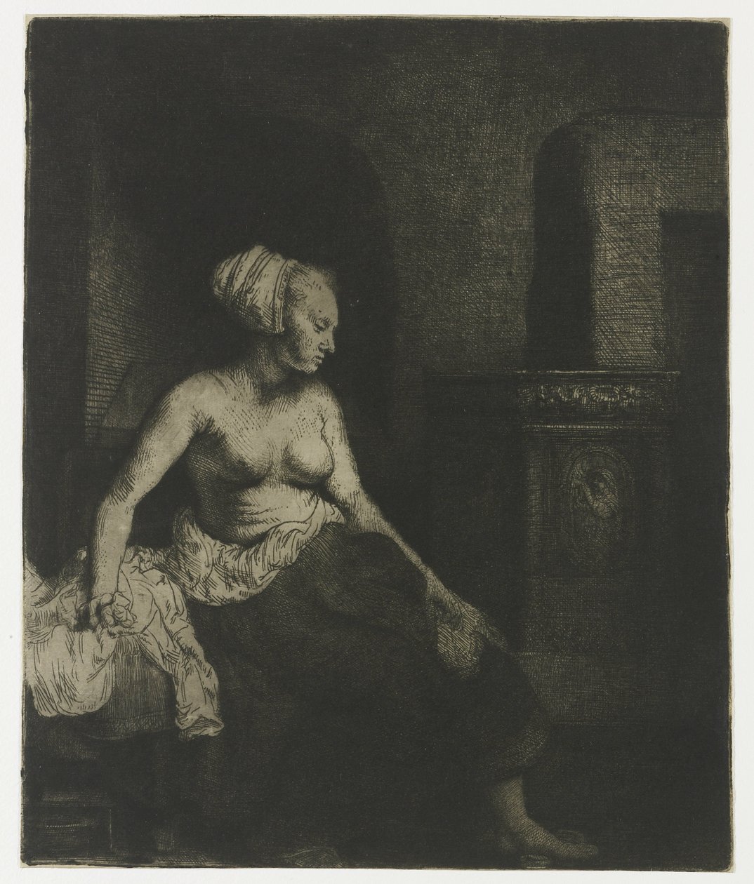 Halb angezogene Frau sitzt neben einem Ofen von Rembrandt van Rijn