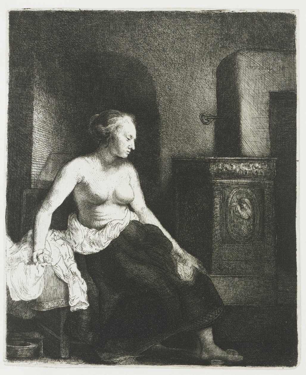Halb bekleidete Frau sitzt neben einem Ofen von Rembrandt van Rijn