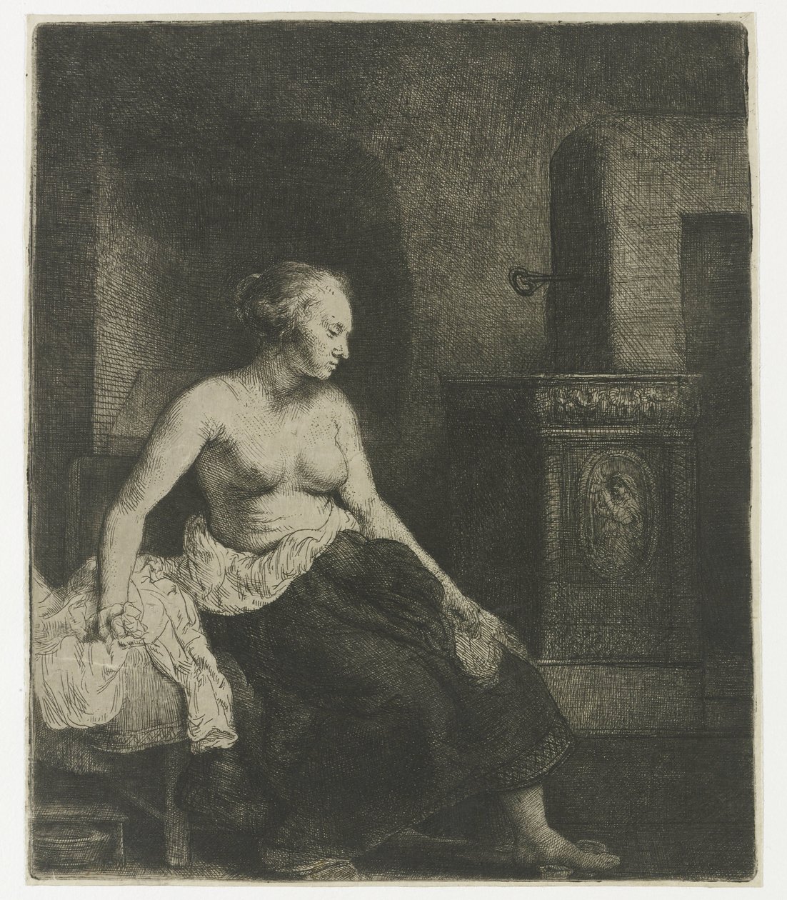 Frau sitzt halb angezogen neben einem Ofen von Rembrandt van Rijn
