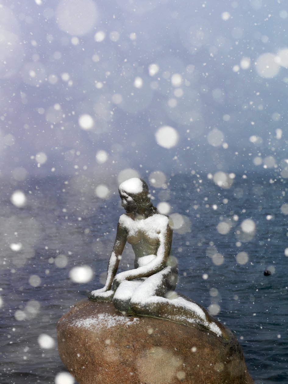 Schneesturm auf der Statue der kleinen Meerjungfrau von Edvard Eriksen, Winter in Kopenhagen, Dänemark, 2022 (Foto) von Sisse Brimberg