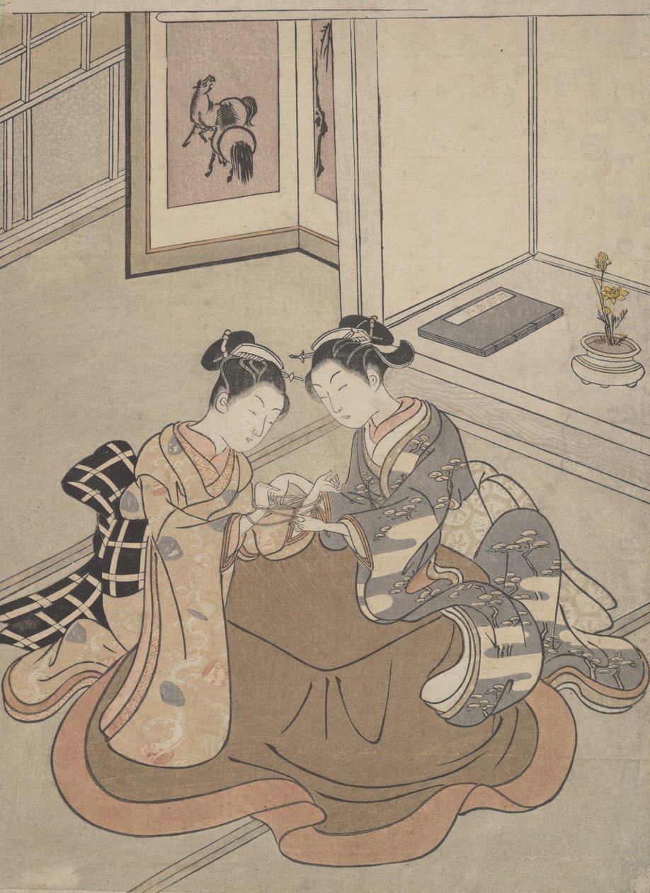 Zwei junge Frauen, die an einem Kotatsu sitzen und Fadenspiele spielen, ca. 1765 von Suzuki Harunobu