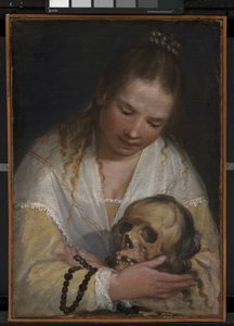 Eine junge Frau betrachtet einen Schädel