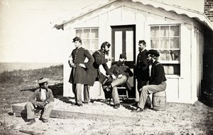 Fünf Soldaten des Bürgerkriegs auf einer Veranda, afroamerikanischer Junge in ihrer Nähe, 1861-65