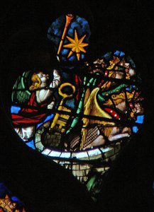 Das westliche Rosenfenster zeigt eine Szene aus dem Buch der Offenbarung: fünfte Trompete; der Stern fällt vom Himmel, der Schlüssel zum bodenlosen Abgrund, und eine riesige Heuschrecke (9:1-6).
