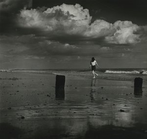 Kind spielt mit den Wellen am Strand