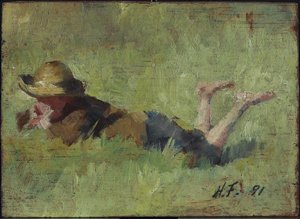 Junge im Gras liegend