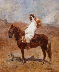 Ein Araber auf einem Pferd in einer Wüstenlandschaft