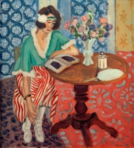 Frau liest an einem Tisch von Henri Matisse