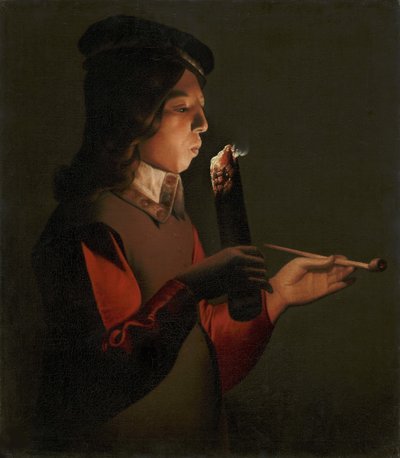 Ein Junge mit einer Pfeife, der auf einen Feuerbrand bläst von Georges de La Tour