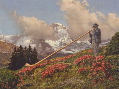 Schweiz: Ein Alphornbläser, die Jungfrau im Hintergrund von Jean Gaberell