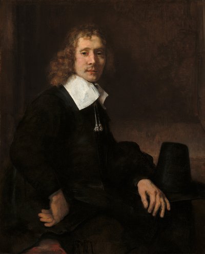 Ein junger Mann an einem Tisch (möglicherweise Govaert Flinck) von Rembrandt van Rijn