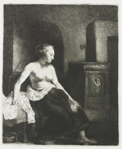 Halb bekleidete Frau sitzt neben einem Ofen von Rembrandt van Rijn