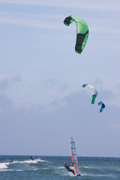 Deutschland, Schleswig-Holstein, Insel Sylt, Fallschirmsurfen und Windsurfer auf Wellen im Meer von Unbekannt Unbekannt