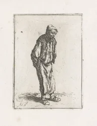 Stehender Mann mit den Händen auf dem Rücken