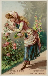 Mädchen riecht an den Rosen
