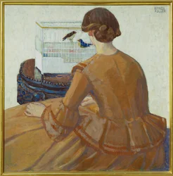 Junge Frau vor einem Vogelkäfig