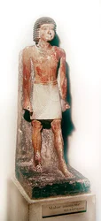Statue eines stehenden Mannes mit einem weißen Schenti