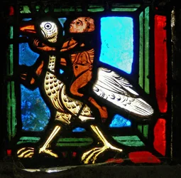 Eckstück eines Fensters, das das Gleichnis vom barmherzigen Samariter darstellt: Mann und Vogel