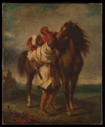 Araber sattelt sein Pferd