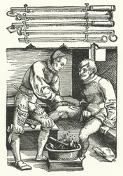 Ein Chirurg kauterisiert die Beinwunde eines Soldaten