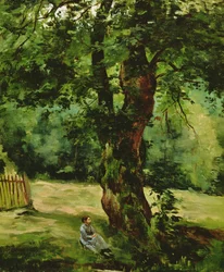 Frau sitzt unter einem Baum