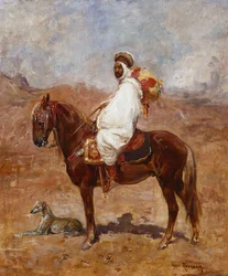 Ein Araber auf einem Pferd in einer Wüstenlandschaft