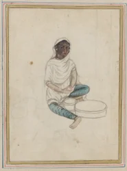 Frau beim Kornmahlen