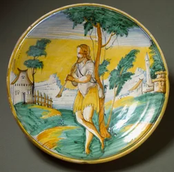 Flötenspieler in einer Landschaft. Keramikteller, hergestellt in Viterbo, Italien. Ende des 16. Jahrhunderts, Florenz, Museo Nazionale del Bargello