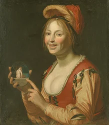 Lachendes Mädchen zeigt ein kleines Bild einer nackten Frau von hinten
