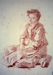 Kleines Mädchen, das auf ihren Fersen sitzt