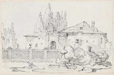Haus und Bäume hinter einer Gartenmauer