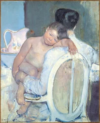 Frau sitzt mit einem Kind auf dem Arm, ca. 1890