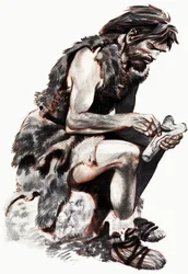 Höhlenmensch schnitzt an einem Knochen