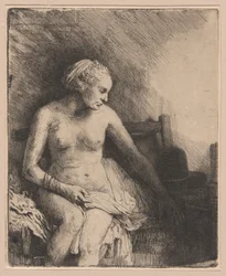 Frau beim Bad mit einem Hut neben ihr