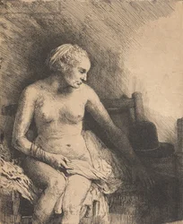 Frau beim Bad mit einem Hut neben ihr