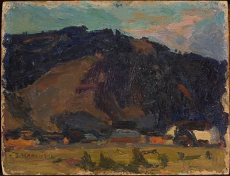 Blick auf ein Dorf vor einem Berg