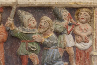 Altarbild. Polychromer Stein. Zweite Hälfte des 14. Jahrhunderts. Ursprung ehemalige Pfarrkirche von Torre de Rialb. Detail. Mittleres Register. Linkes Panel. Unterer Teil: Ein Beamter beobachtet die Szene der Enthauptung von Saint Iscle und der Amputation