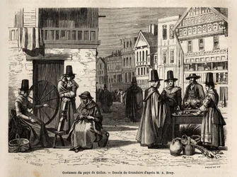 Eine Straße in Wales, mit Einheimischen in traditionellen Kostümen und alltäglichen Aktivitäten: eine Familie und Frauen, die Wolle mit Rädern spinnen. Gravur zur Illustration einer Reise in das Land Wales, 1862, von Alfred Erny, in „Le tour du monde, nouv