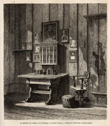 Martin Luthers Zimmer (1483-1546) auf der Wartburg, wo er nach seiner Exkommunikation im Jahr 1521 Zuflucht fand, mit seinem Porträt und denen seiner Eltern über dem Schreibtisch, unter deren Augen er die Bibel ins Deutsche übersetzte und seine berühmteste