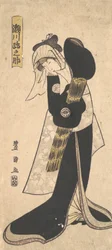 Der Schauspieler Segawa Kikunojō III. als Frau in schwarzem Gewand mit einem Strohhut, 1798.