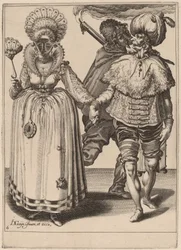 Ein Mann mit Turban führt eine Frau mit Pfauenfedern